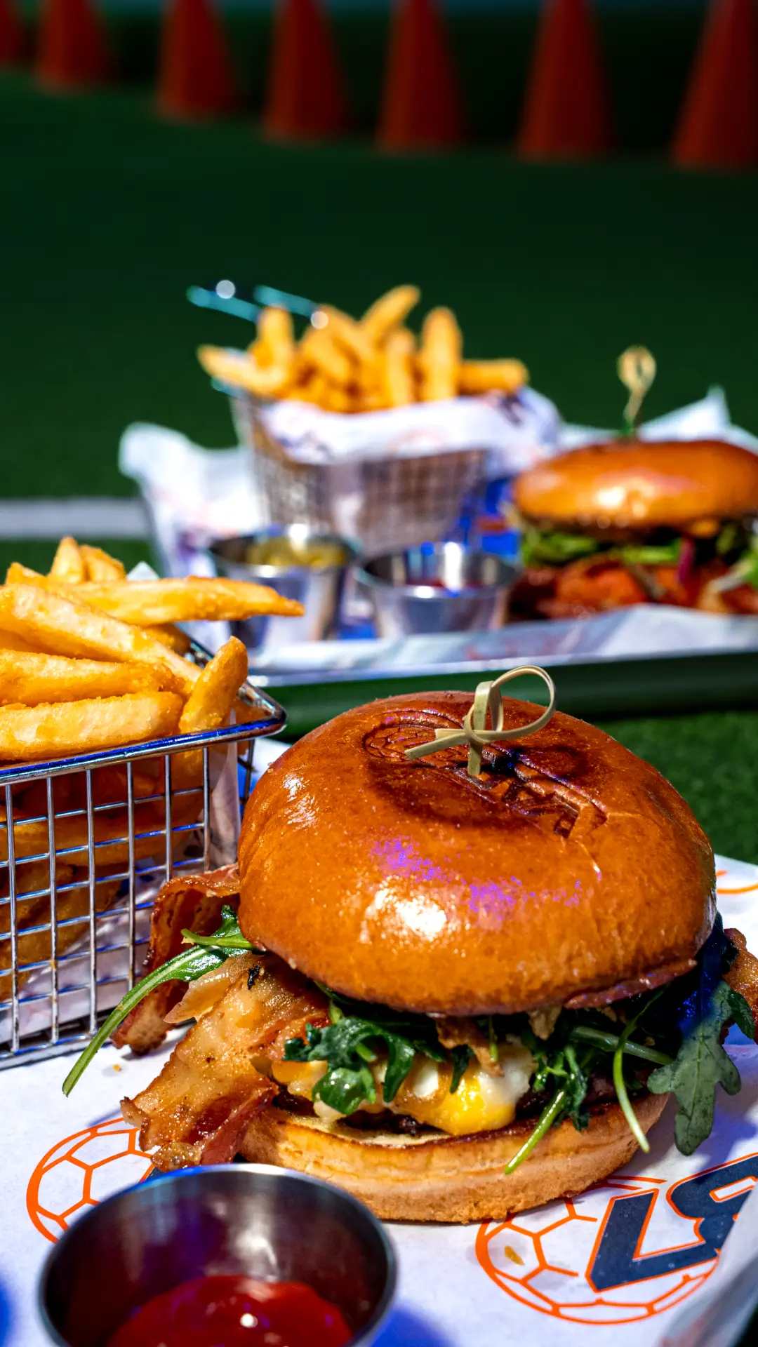 Hamburguesa con tocino y canasta de papas sobre papel VAR 37